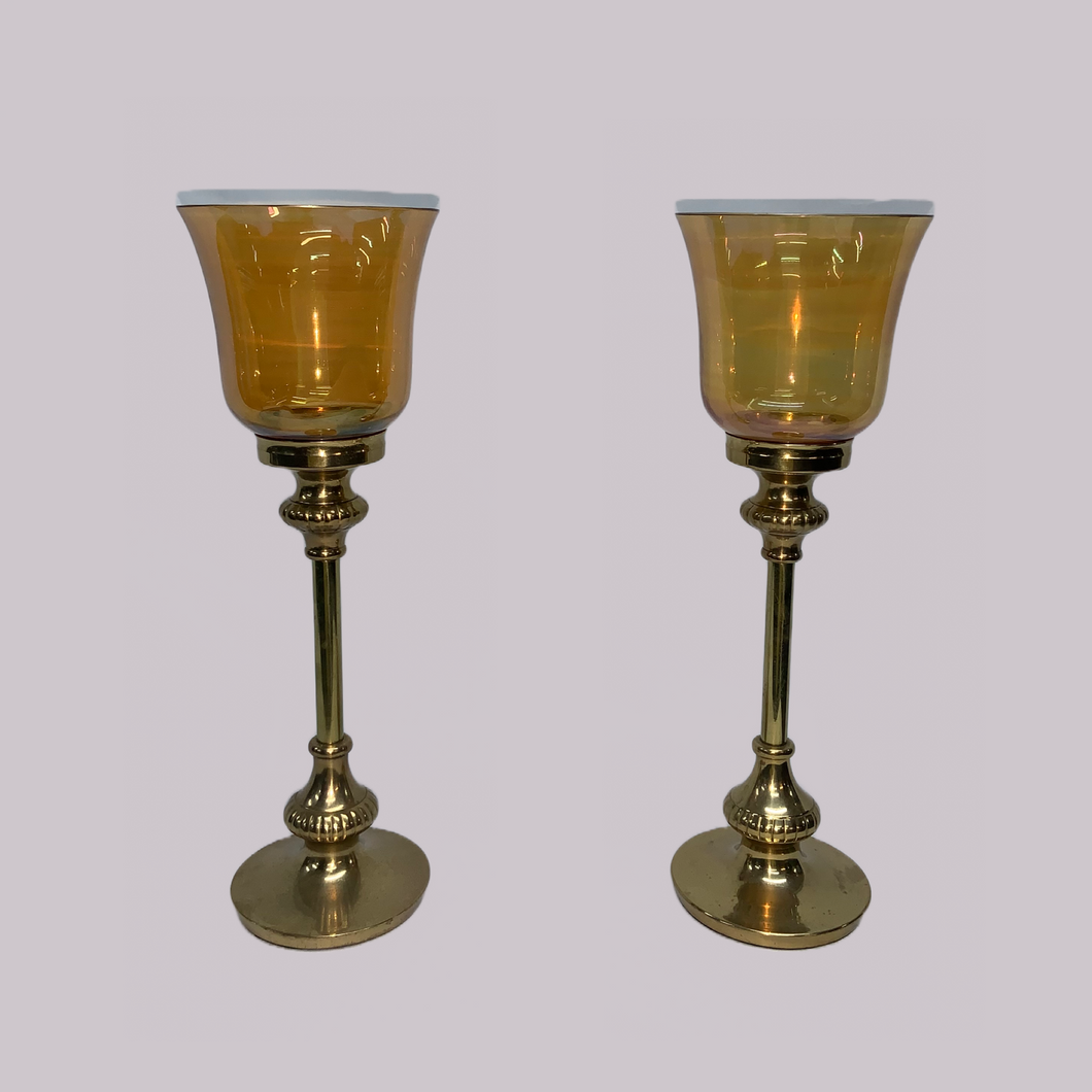 Brass candlesticks with gold-coloured glass shades